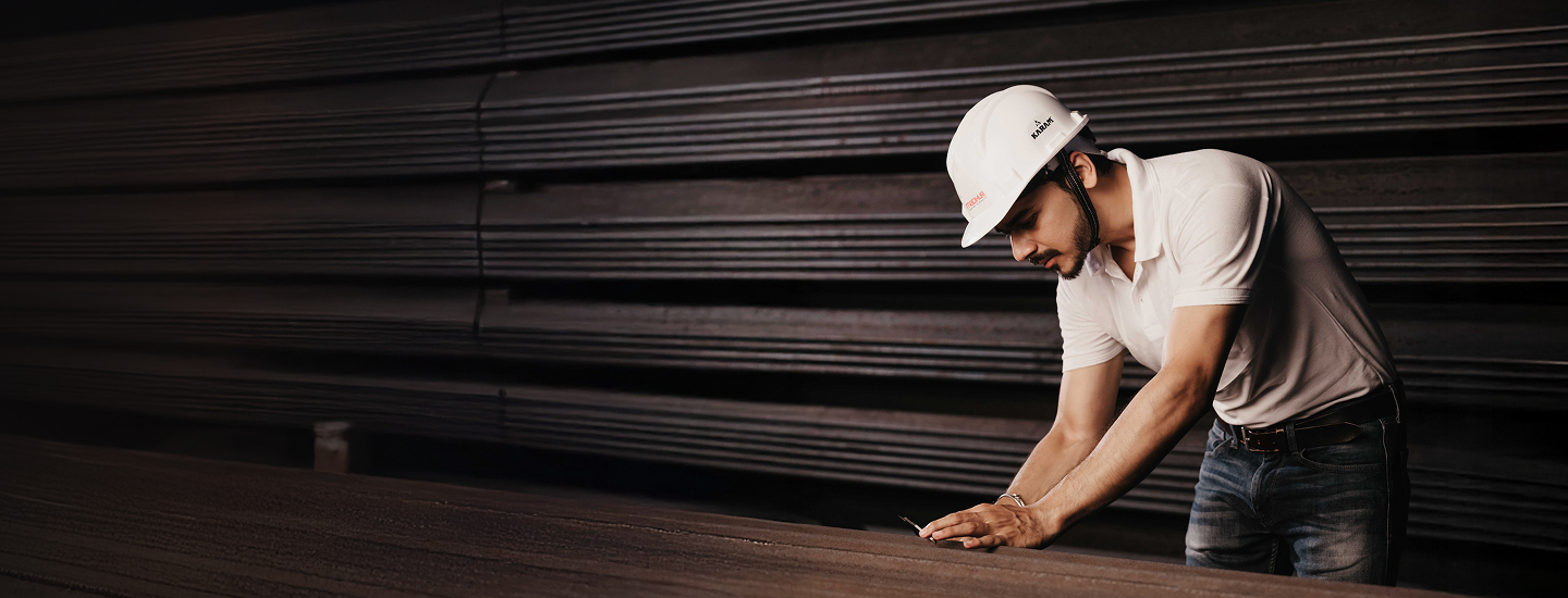 Madhur engineer inspecting steel stock